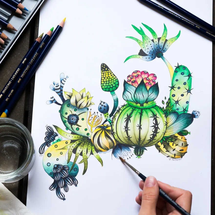 A finished page of colored cacti and succulents with pencils and a water glass