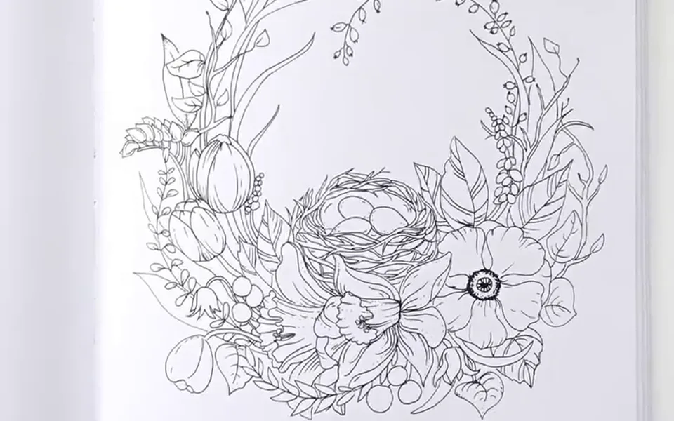 A line drawing of a floral wreath with a bird's nest, ready to color