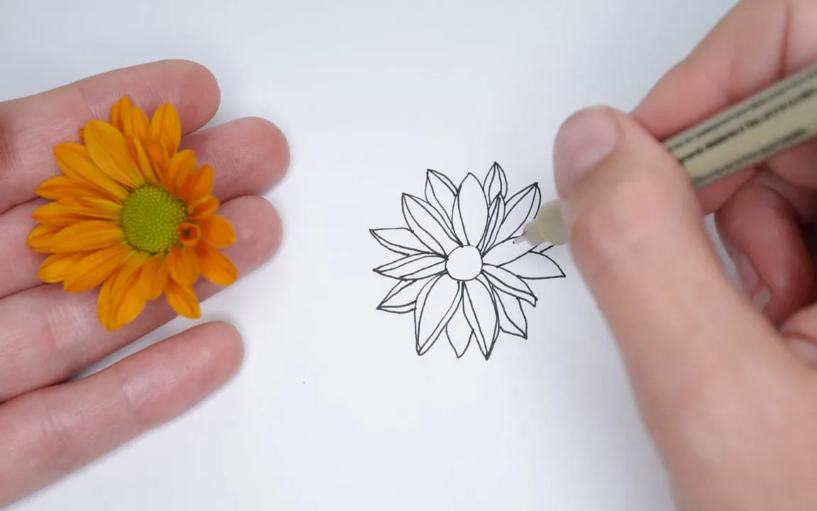 Rachel drawing a flower from a real one held in her hand, from the Drawing 101 lesson