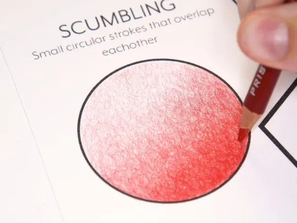 A circle shaded in red pencil with small circular strokes