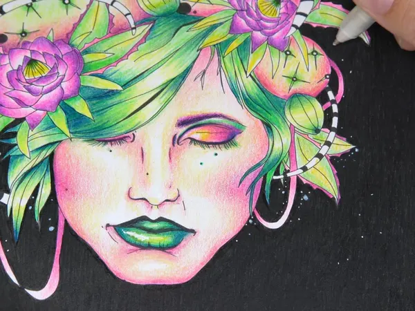 A face with green hair and pink flowers colored on black paper